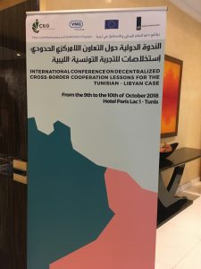 A banner with logo's that states the title of the conference in multiple languages, including the time and date